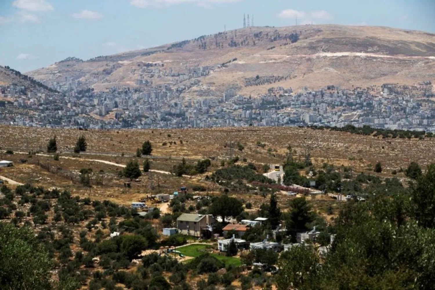 A general view picture shows a section of Itamar, a Jewish settlement, in the foreground as Nablus is seen in the background, in the Israeli-occupied West Bank, June 15, 2020. (Reuters)