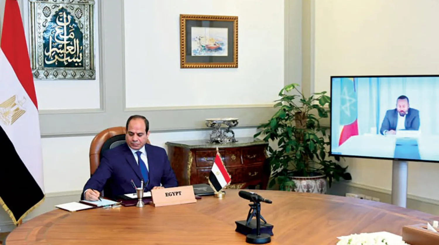 السيسي خلال مشاركته في القمة الأفريقية حول السد أول من أمس، ويبدو رئيس وزراء إثيوبيا آبي أحمد على الشاشة (الرئاسة المصرية)