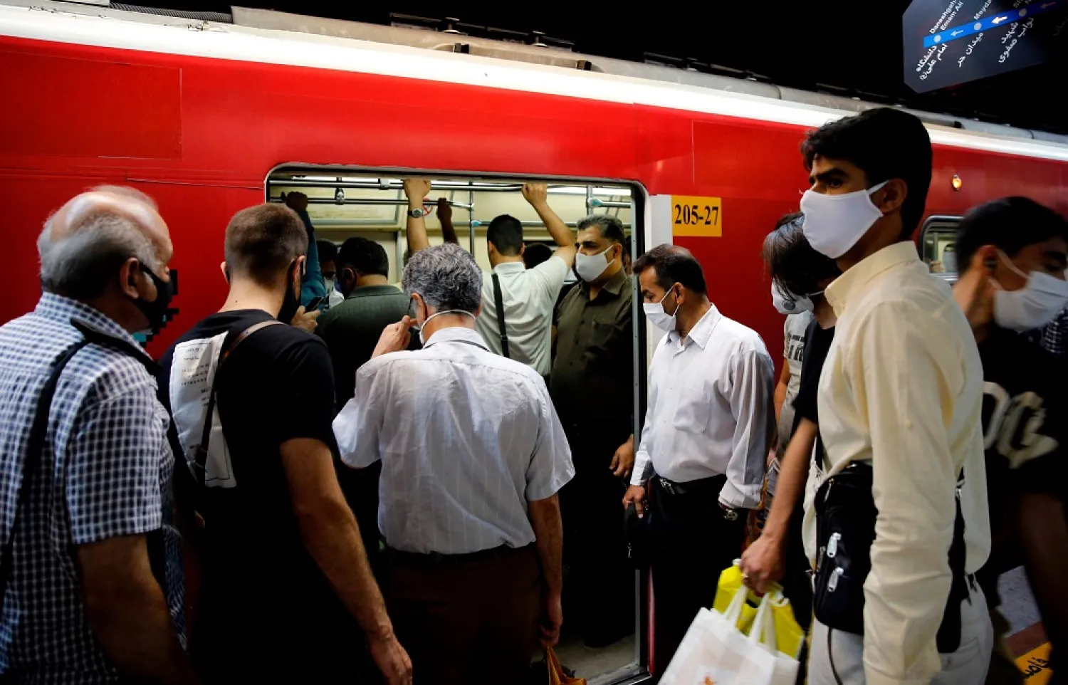 Iranians, mostly wearing face masks, are pictured at a metro station in the capital Tehran on June 10, 2020, amid the COVID-19 pandemic. (AFP)