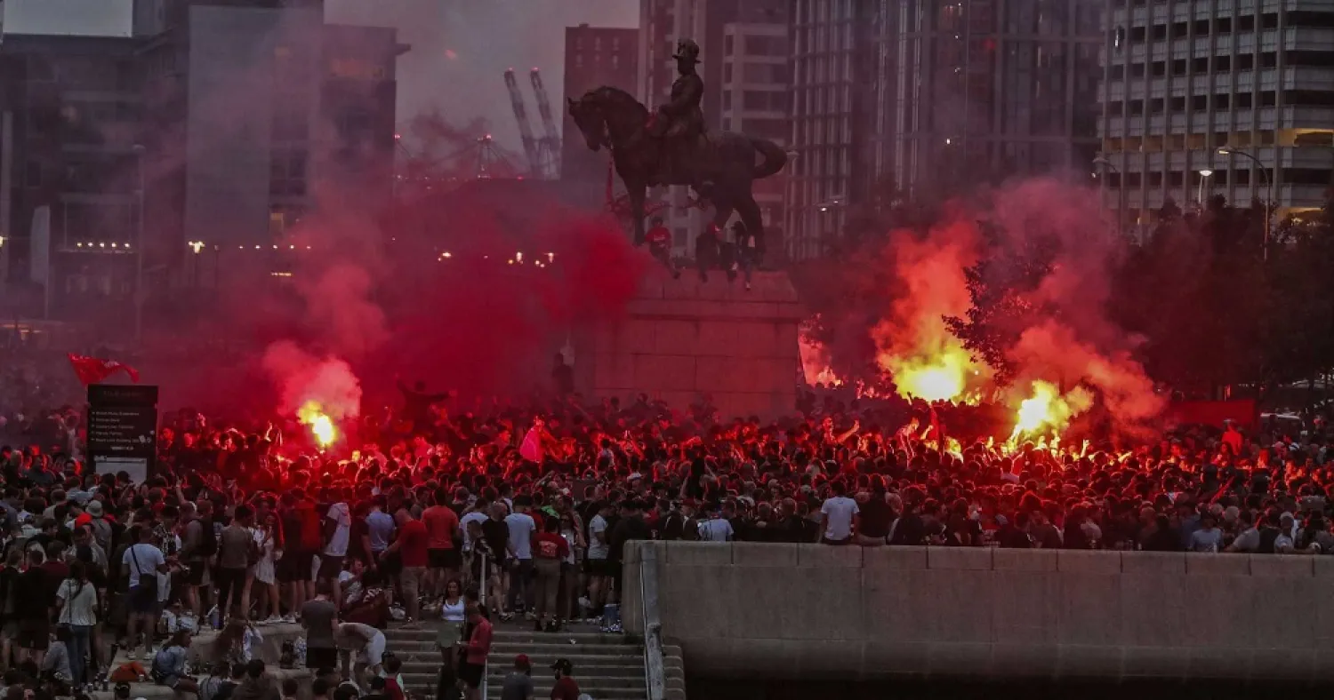 Liverpool fans let off flares outside the Liver Building in Liverpool, England, Friday, June 26, 2020. (AP)
