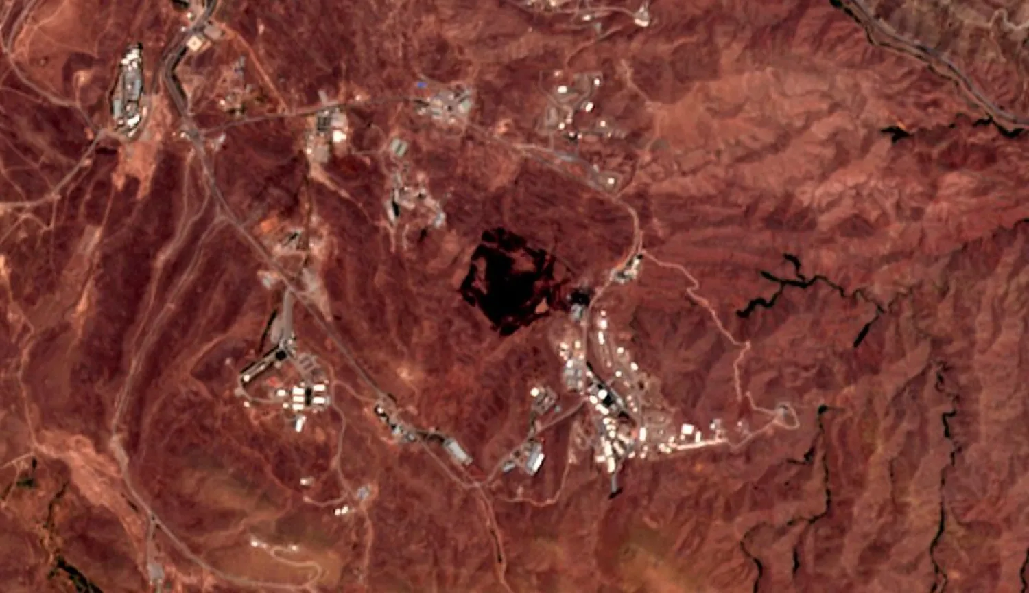 This Friday, June 26, 2020, photo from the European Commission's Sentinel-2 satellite shows the site of an explosion that rattled Iran's capital. Analysts say the blast came from an area in Tehran's eastern mountains they hides an underground tunnel system and missile production sites. The explosion appears to have charred hundreds of meters of scrubland. (European Commission via AP)
