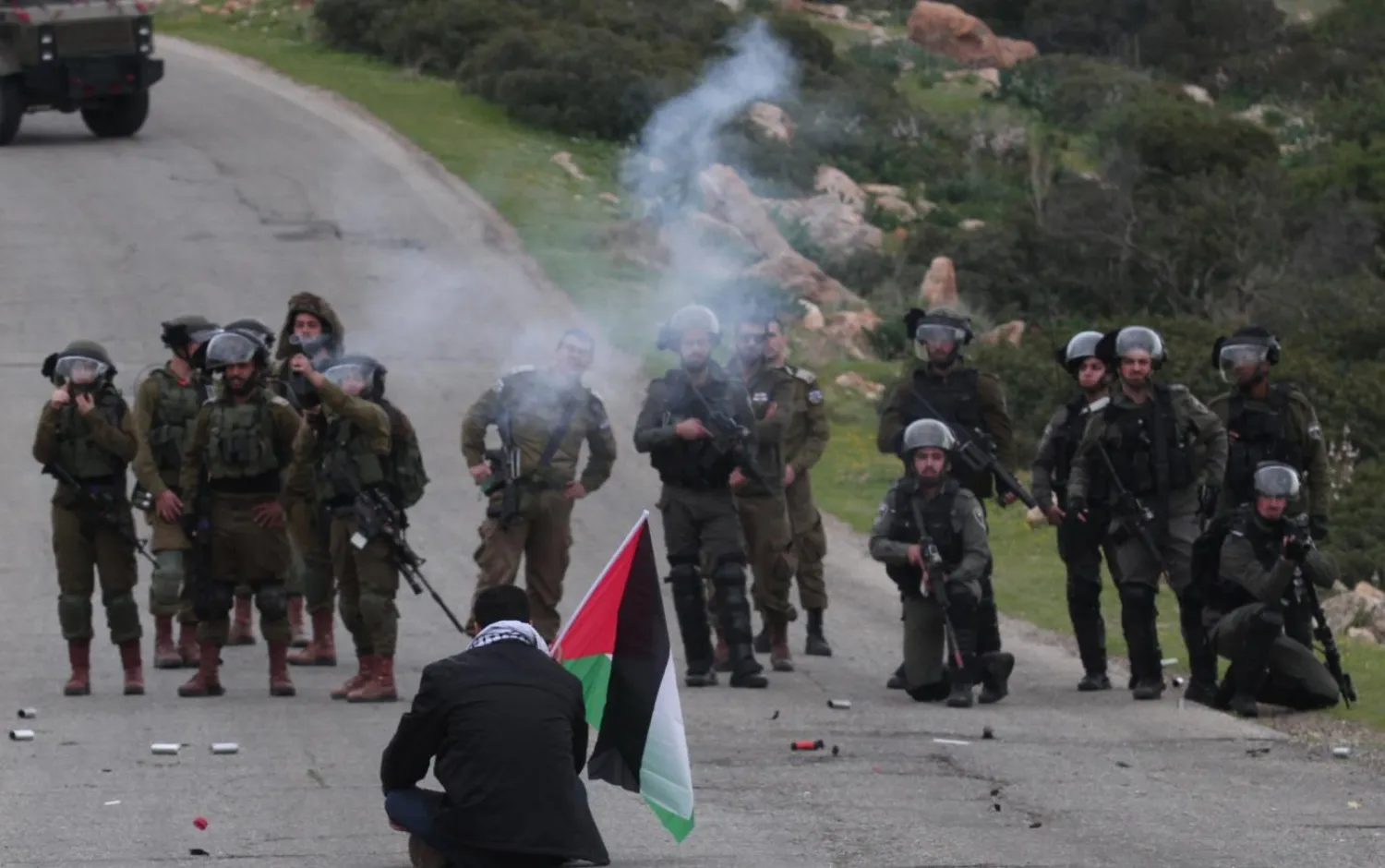 An unarmed Palestinian protester facing Israeli soldiers at the Tayasir checkpoint near the West Bank city of Tubas on 25 February (Reuters)
