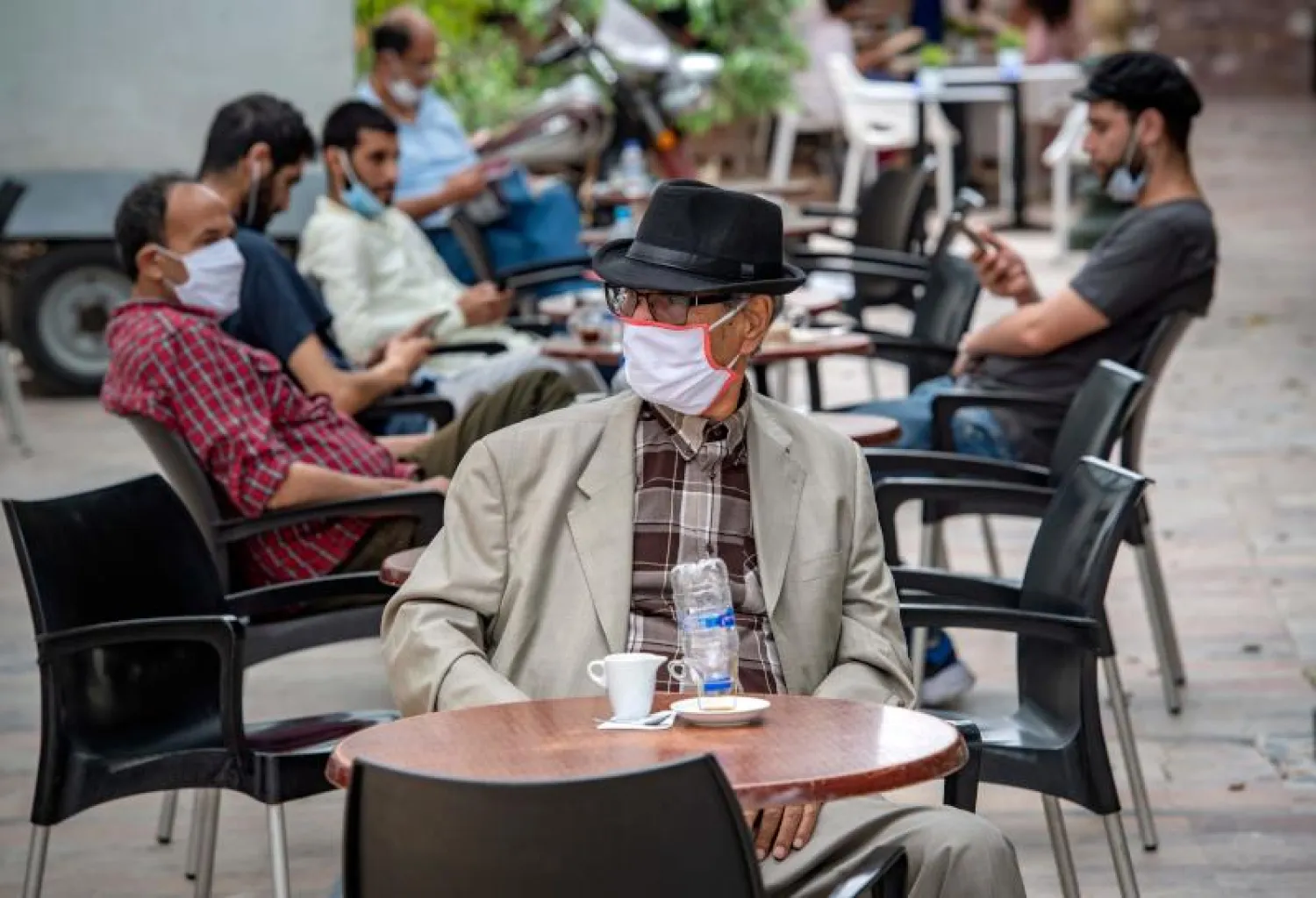 مغاربة يجلسون بأحد المقاهي في العاصمة الرباط (أ.ف.ب)