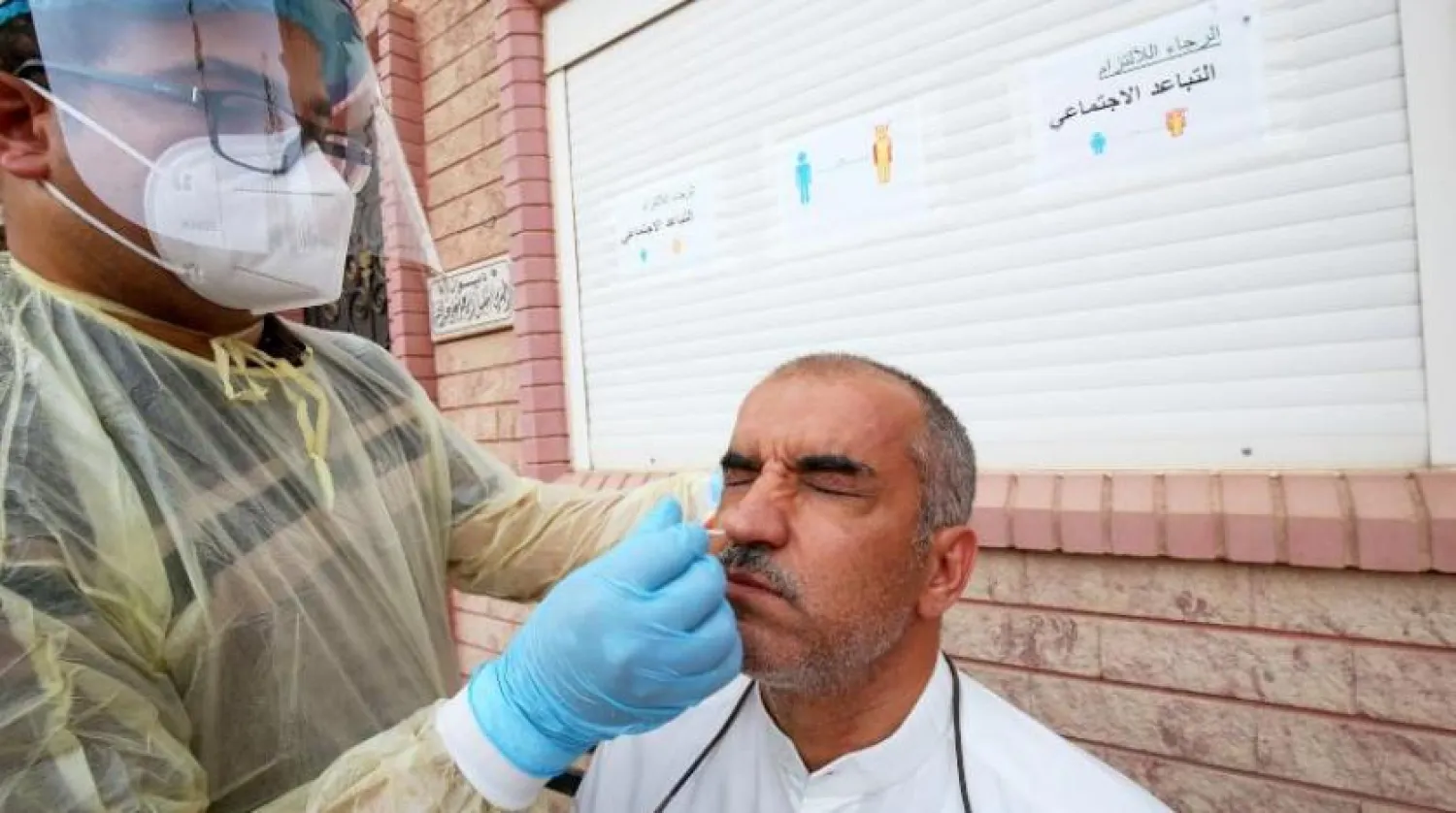 A Kuwaiti health ministry worker conducts a random test for the novel coronavirus (COVID-19) in Kuwait City on June 27, 2020. (Photo by YASSER AL-ZAYYAT / AFP)