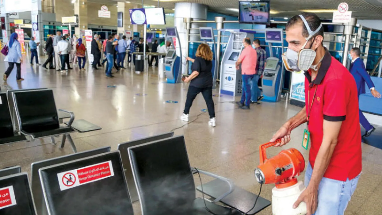 جانب من تعقيم مطار القاهرة الدولي قبيل افتتاحه المقرر مطلع يوليو (إ.ب.أ)