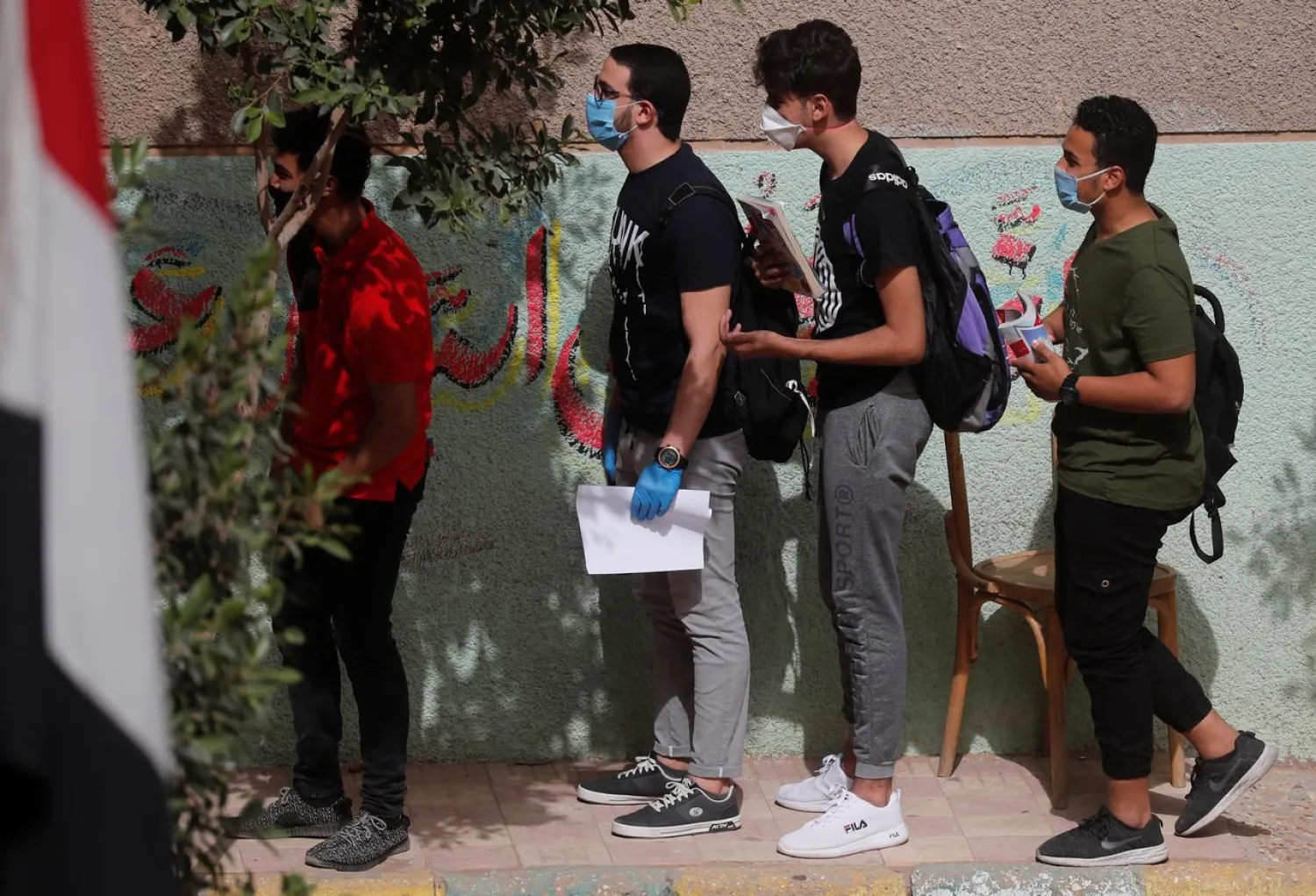High school students wearing protective masks wait in line during the first day of final exams, amid concerns over the coronavirus disease outbreak, in Cairo, Egypt June 21, 2020. (Reuters)