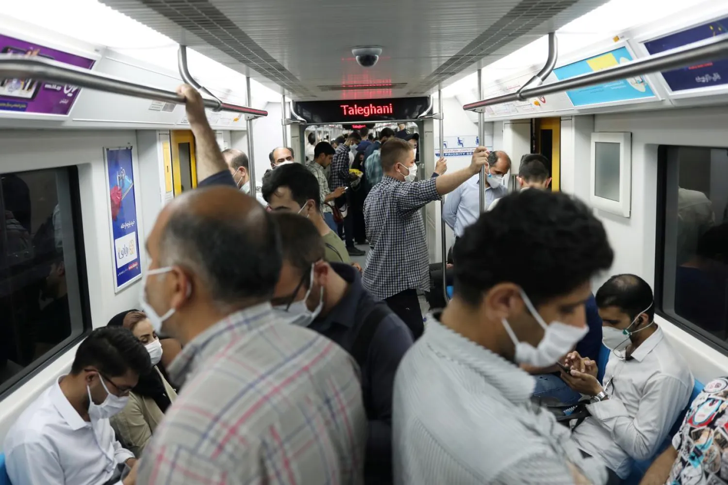 Iranians wearing protective face masks ride the metro, following the outbreak of the coronavirus disease (COVID-19), in Tehran, Iran, June 28, 2020. (Reuters)