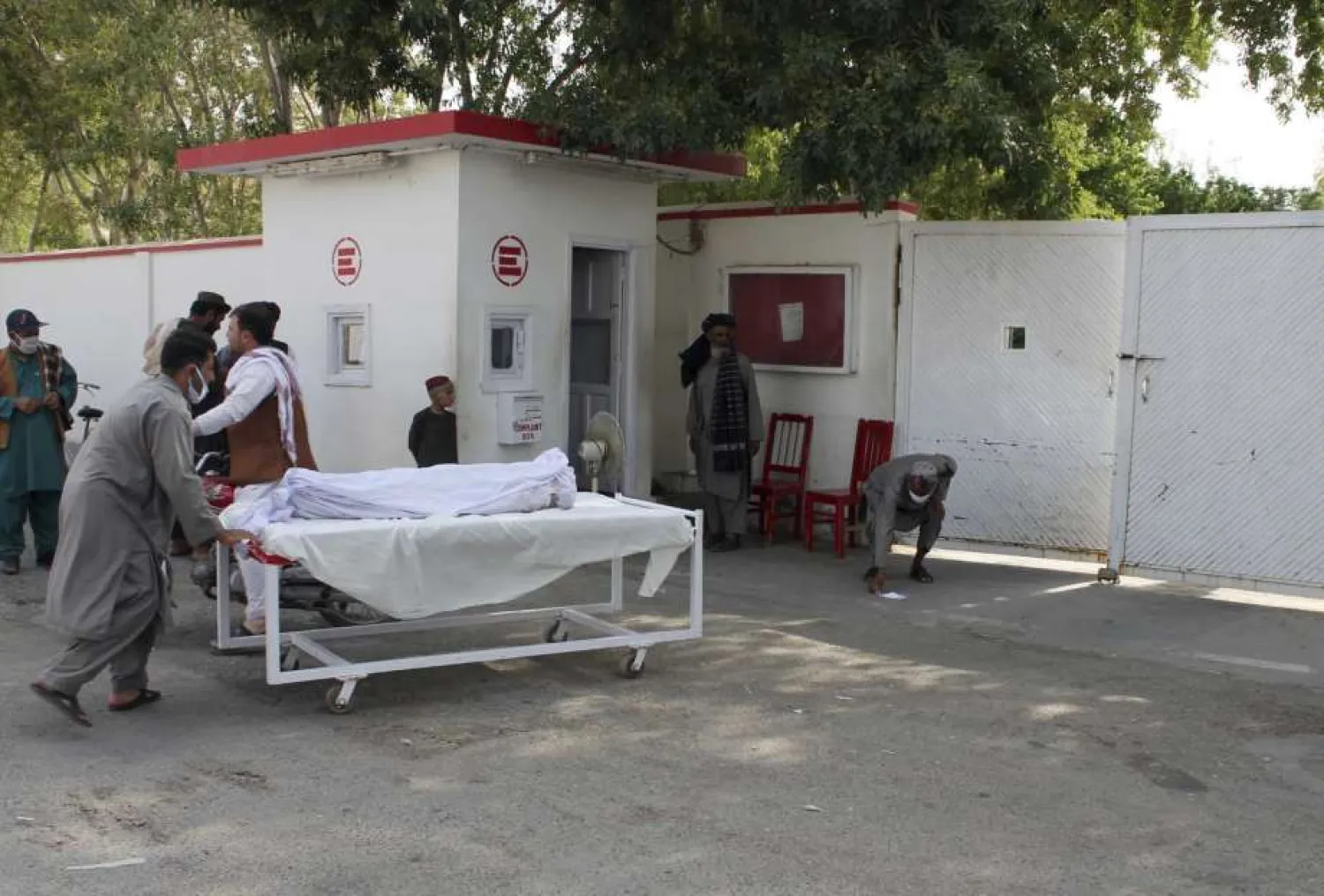 The body of a man who was killed during a deadly attack is moved on a gurney, in the southern Helmand province, Monday, June 29, 2020. (AP Photo/Abdul Khaliq)