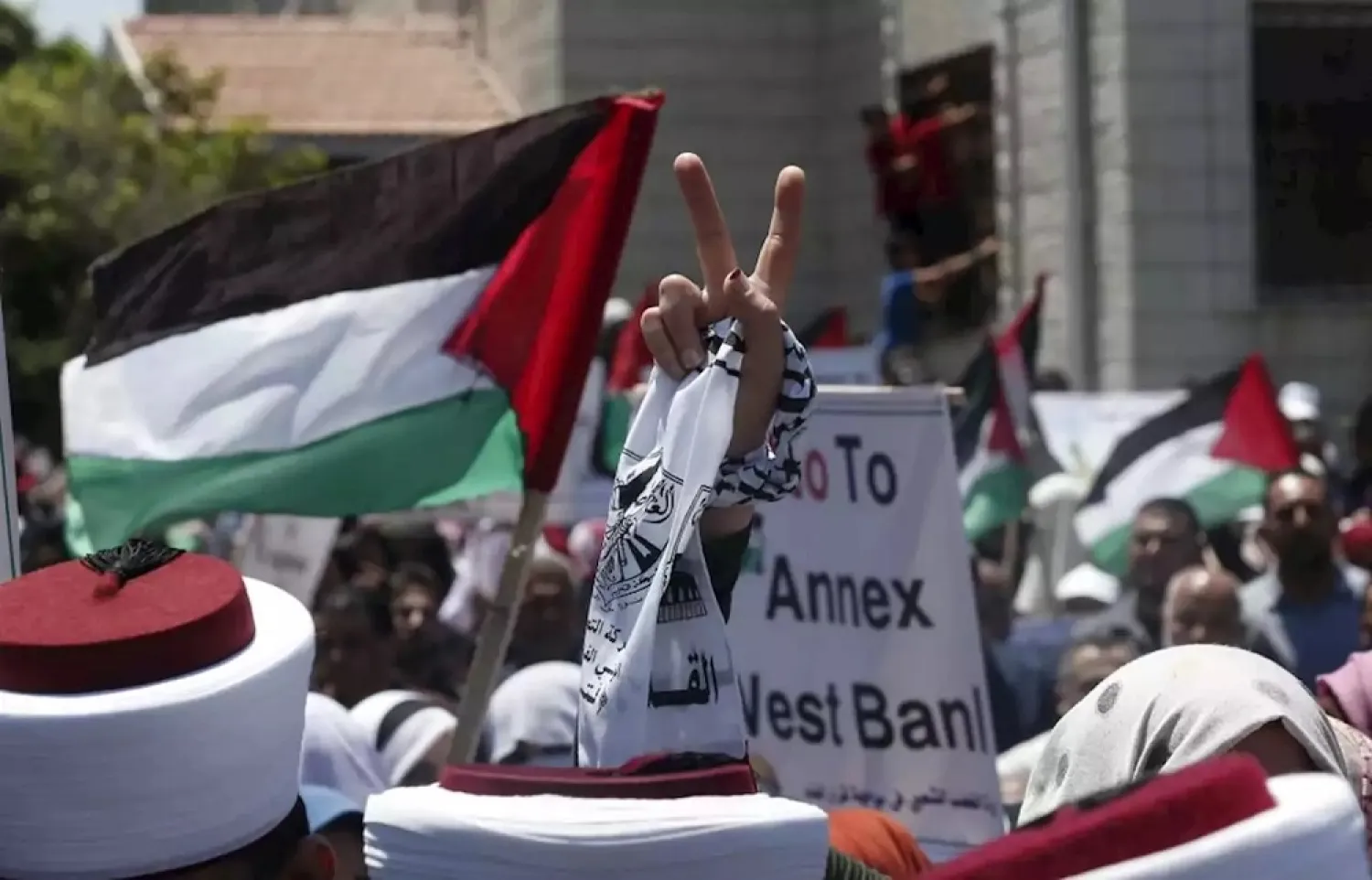A Palestinian demonstrator in Gaza City flashes the victory sign in a ‘Day of Rage’ to protest Israel's plan to annex parts of the occupied West Bank. (AFP)