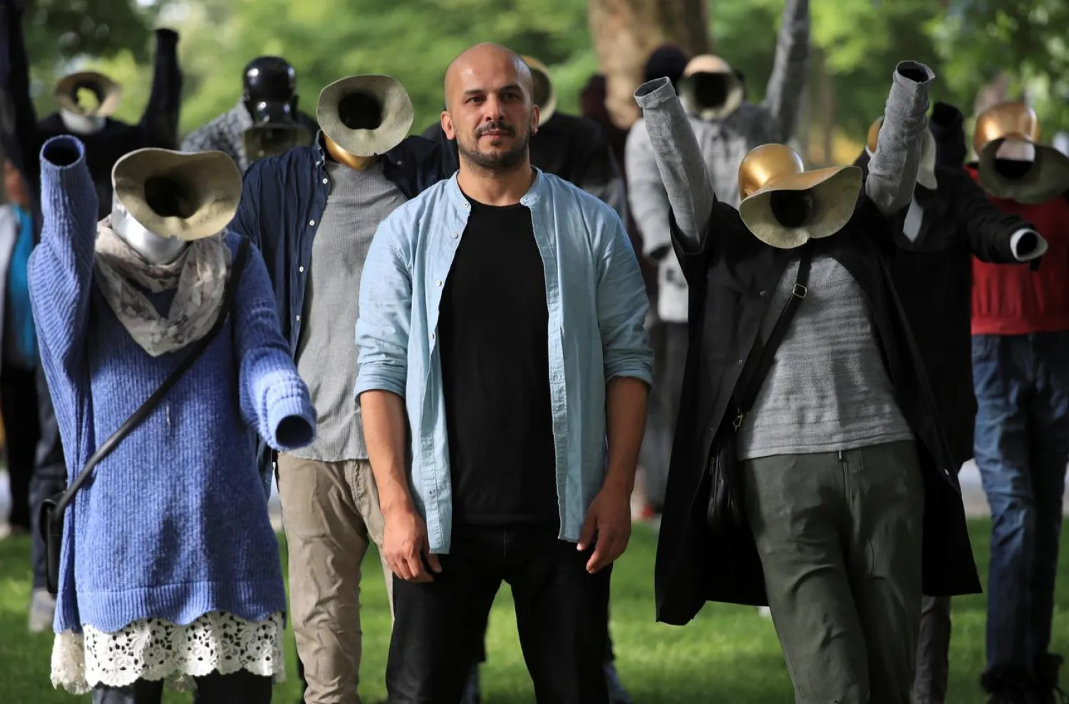Artist Khaled Barakeh stands amid his installation outside a court during the trial against members of the Syrian regime’s security services in Koblenz, Germany, July 1, 2020. (Reuters)