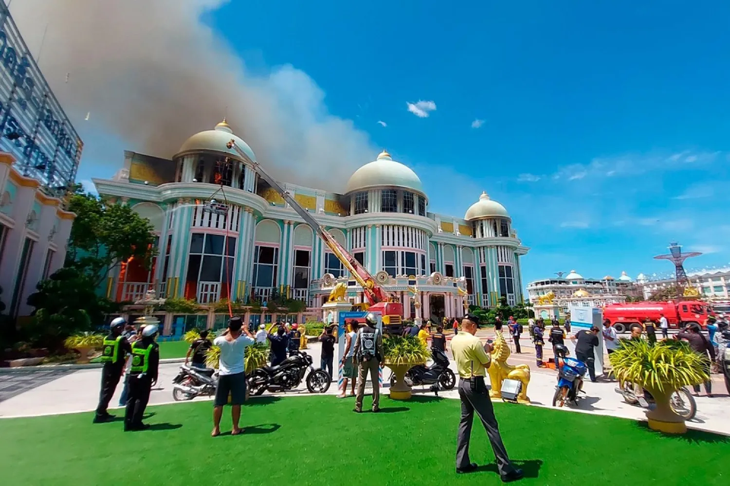 Firefighters attempt to put out a fire of a gaudy mansion in a Buddhist-themed tourist park in Pattaya, Thailand, Wednesday, July 1, 2020. (AP)