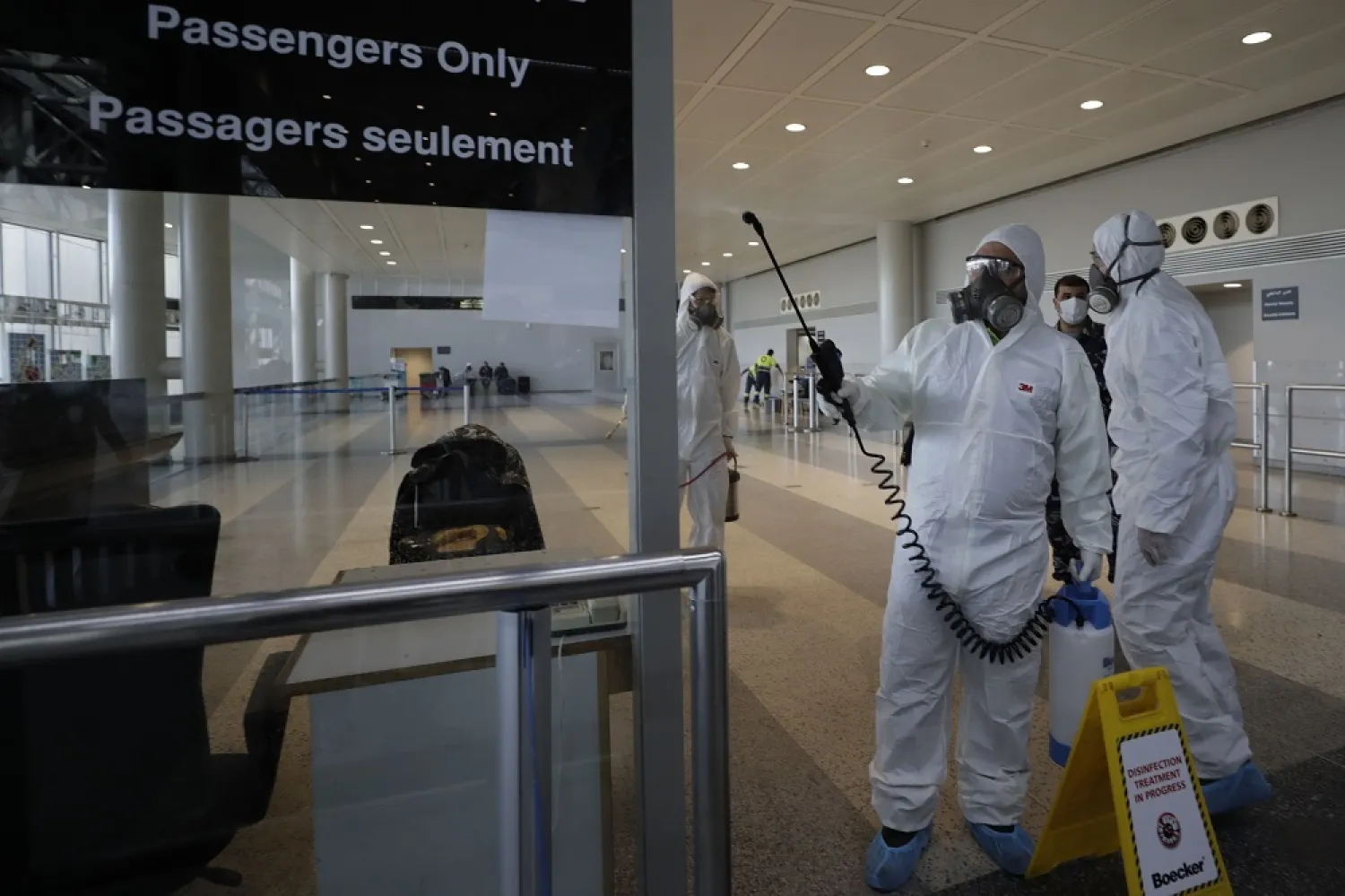 In this March 5, 2020 file photo, workers spray disinfectant as a precaution against the coronavirus outbreak, at the Rafik Hariri International Airport, in Beirut, Lebanon. (AP)