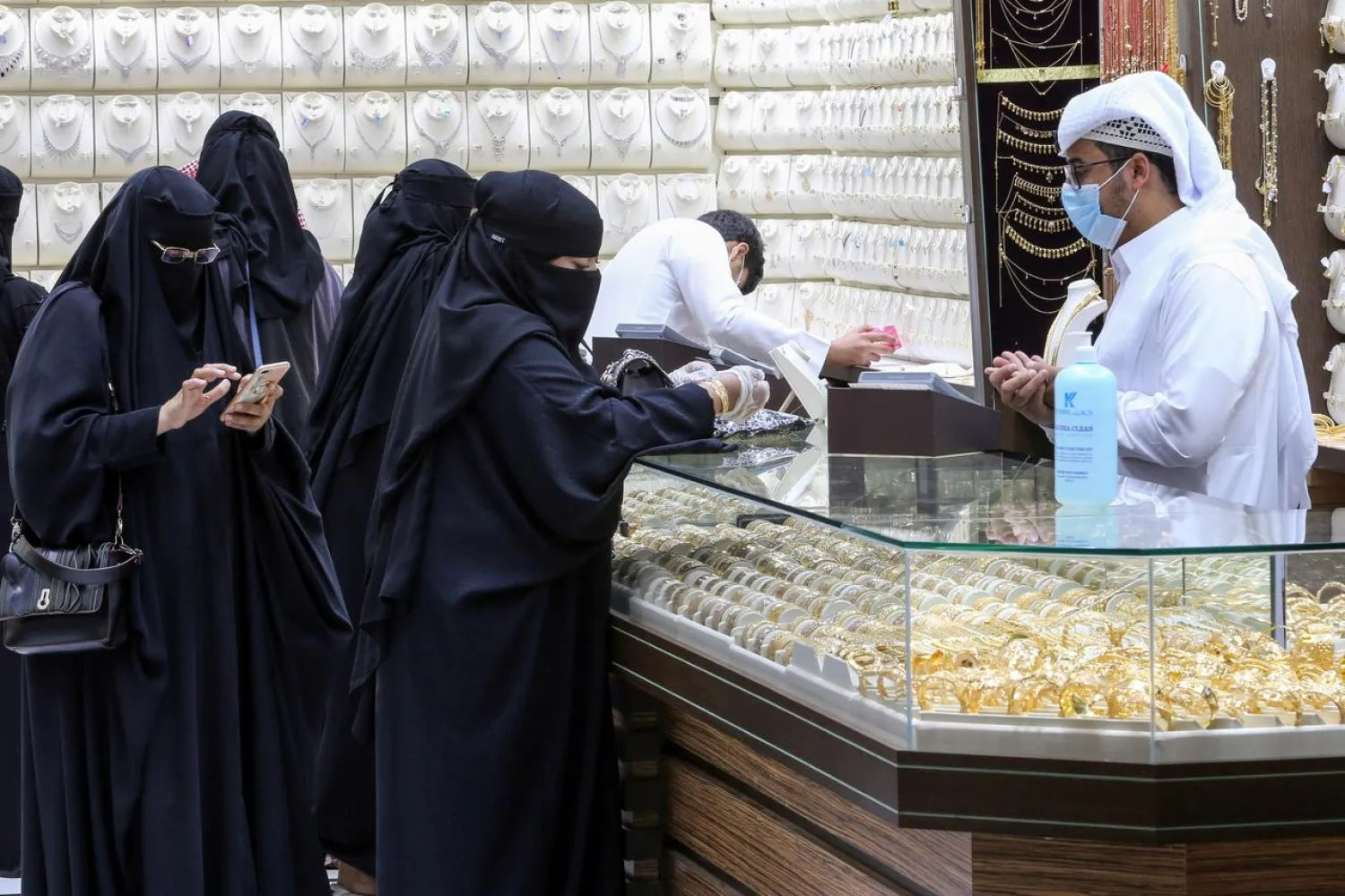 Saudi women buy jewelry at a shop in the gold market before the expected increase of VAT, in Riyadh, Saudi Arabia June 29, 2020. (Reuters)