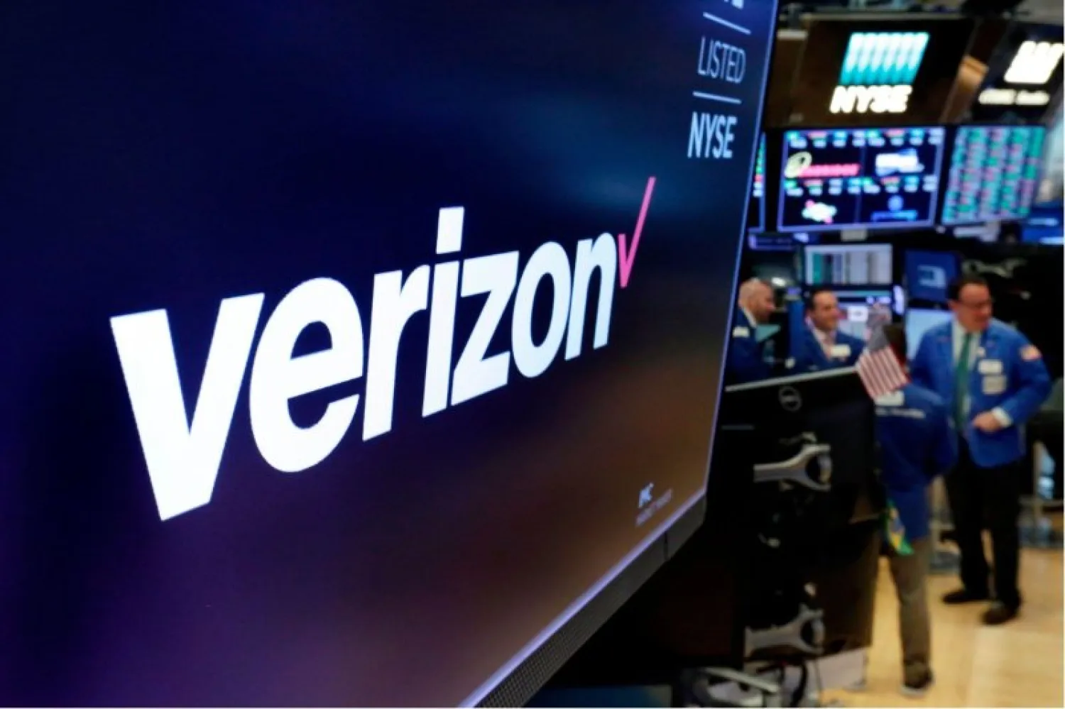This April 23, 2018, file photo shows the logo for Verizon above a trading post on the floor of the New York Stock Exchange. Verizon's decision to join the growing boycott against Facebook and Twitter risks hurting the social media giants where it hurts most: their advertising revenue. Advertising accounts for nearly all Facebook's $70.7 billion annual revenue, and a similar share of Twitter's $3.46 billion. (AP Photo/Richard Drew, File)