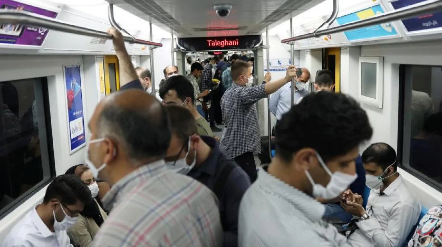 Iranians wearing protective face masks ride the metro, following the outbreak of the coronavirus disease (COVID-19), in Tehran, Iran, June 28, 2020. (Reuters)
