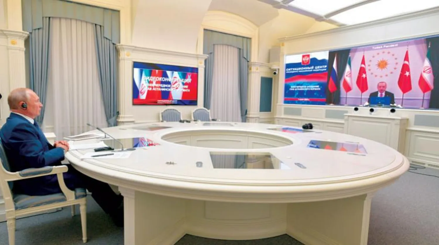 Russian President Vladimir Putin during the three-way television summit with his Turkish and Iranian counterparts (AP)
