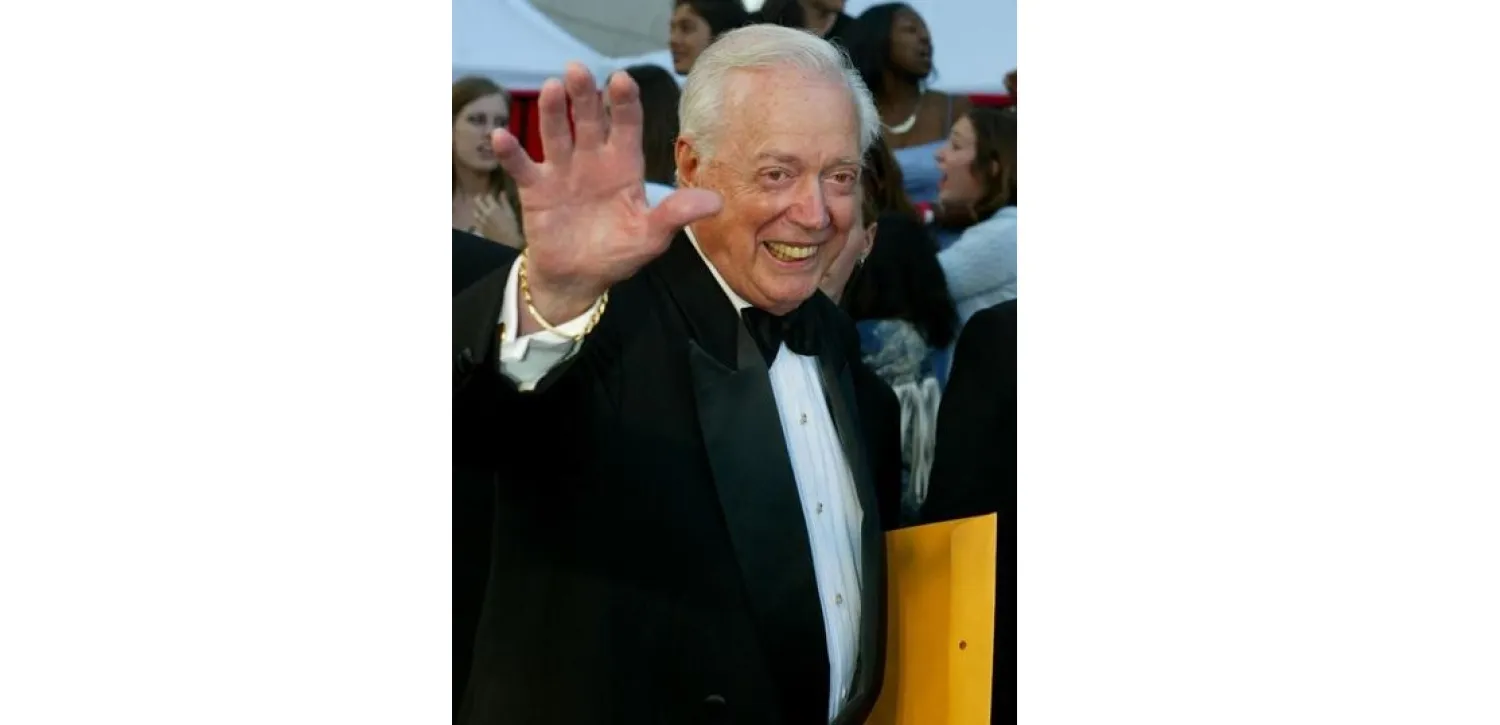 FILE PHOTO: Hugh Downs, former host of the ABC news program "20/20" poses as he arrives for the ABC television networks 50th anniversary in Hollywood, U.S., March 16, 2003. REUTERS/Fred Prouser/File Photo
