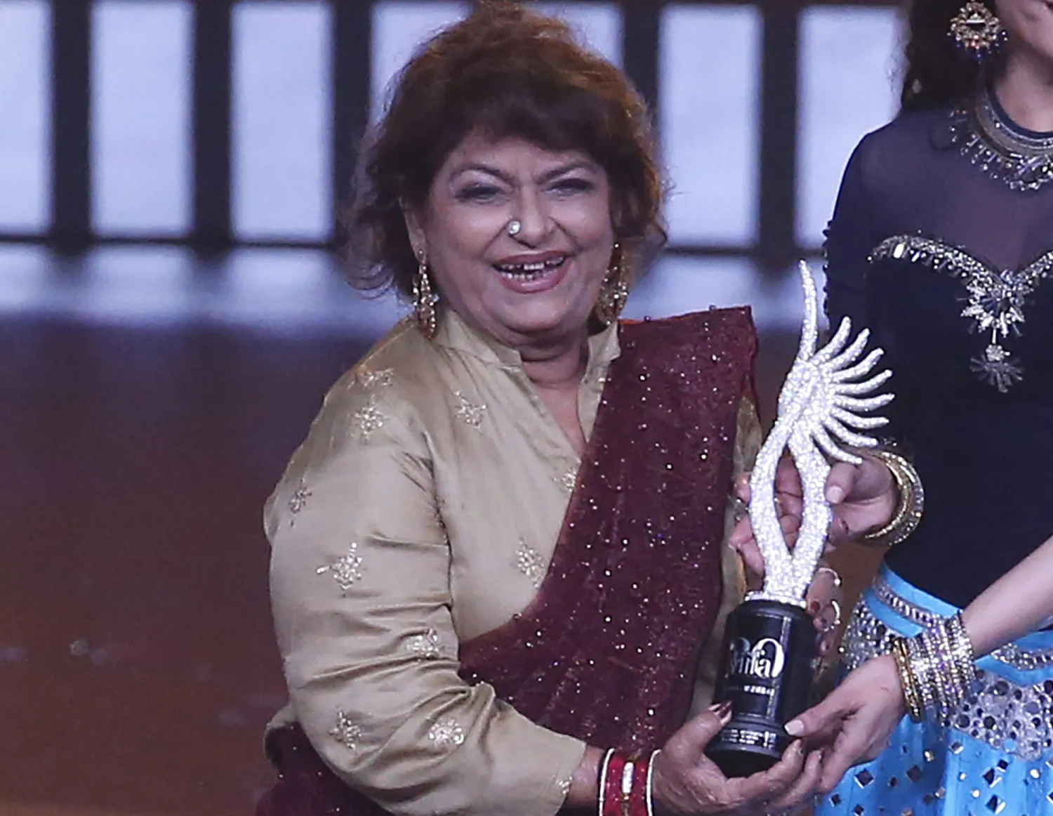 FILE - In this Sept. 19, 2019, file photo, Indian choreographer Saroj Khan is presented a special award during the 20th International Indian Film Academy (IIFA) awards ceremony in Mumbai, India. (AP Photo/Rafiq Maqbool, File)