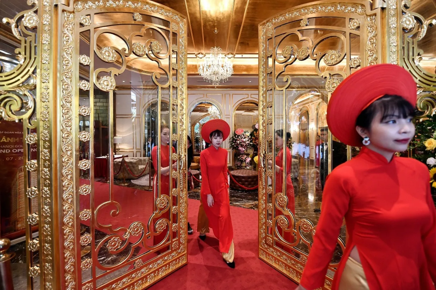 Staff wait to welcome guests in the lobby of the newly-inaugurated Dolce Hanoi Golden Lake hotel, the world's first gold-plated hotel. (AFP)