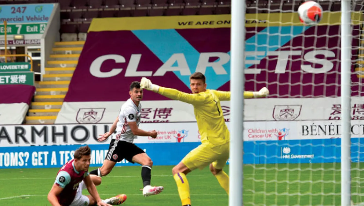 الآيرلندي جون إيغان لاعب شيفيلد (أقصى اليمين) يراقب الكرة التي سددها وهي في طريقها لشباك بيرنلي (أ.ف.ب)