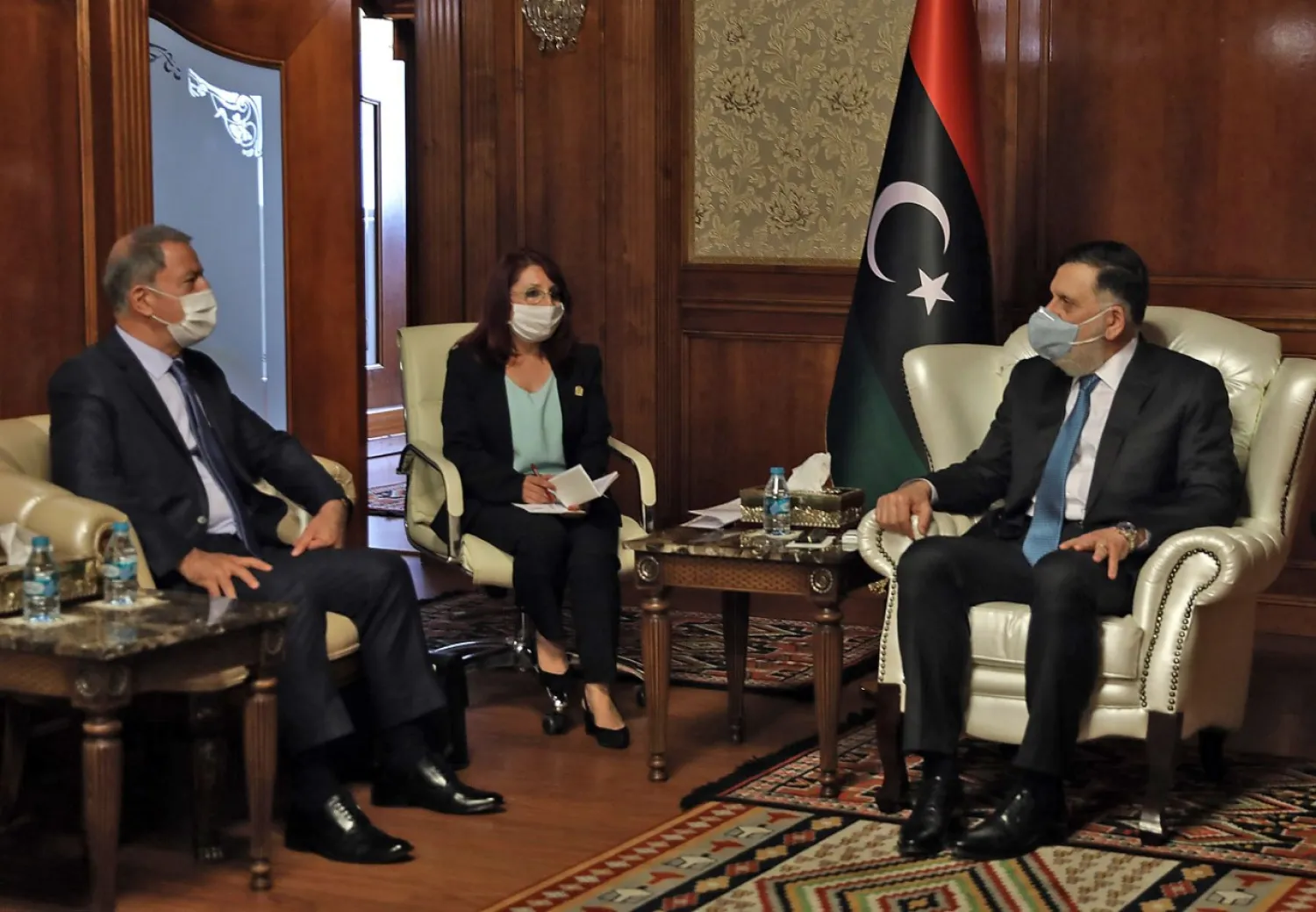 Head of Government of National Accord (GNA) Fayez al-Sarraj receives Turkish Defense Minister Hulusi Akar (L), in the Libyan capital Tripoli on July 3, 2020. (AFP)