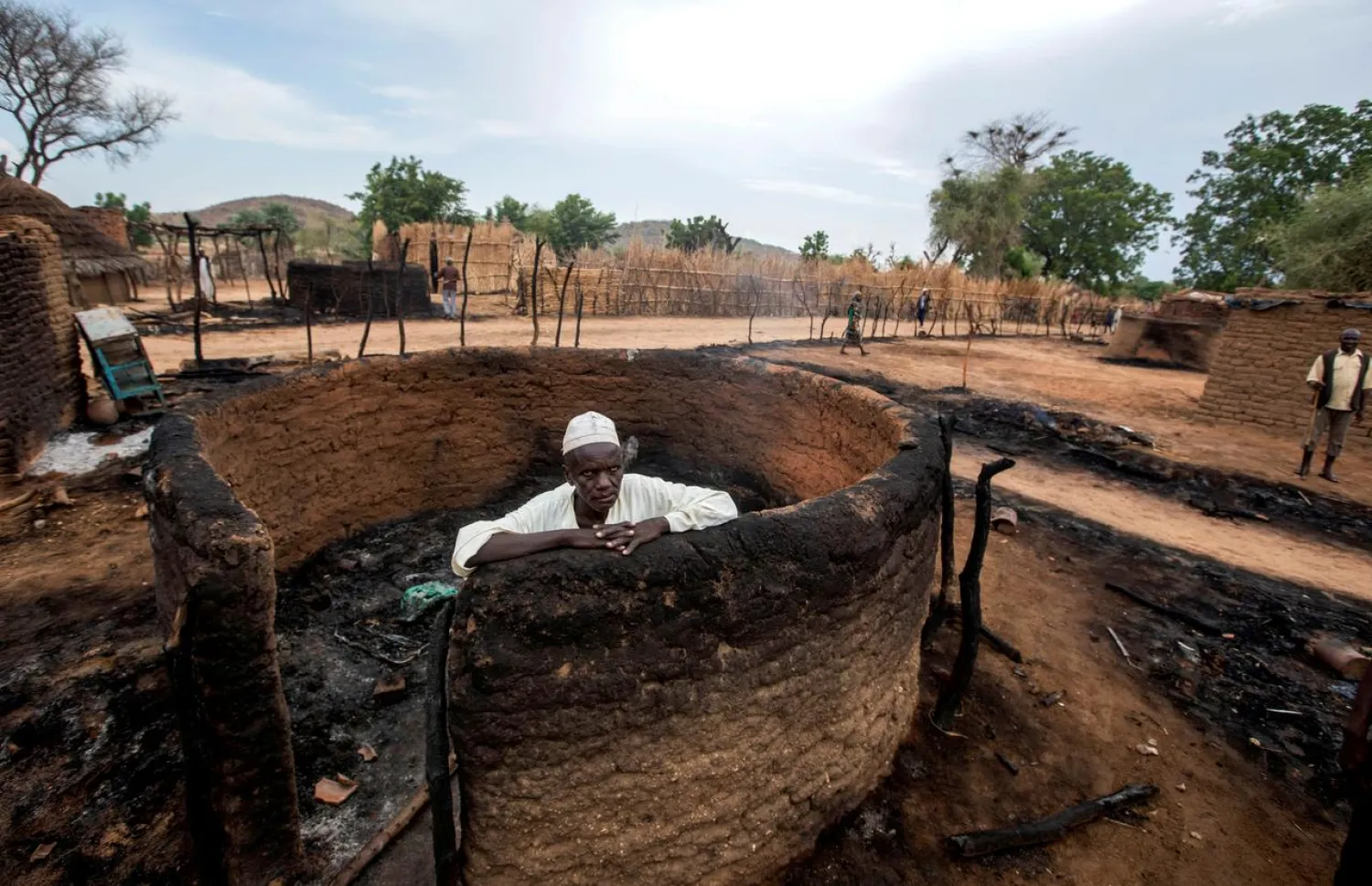 A man is seen inside a burnt house during clashes between nomads and residents in Deleij village, located in Wadi Salih locality, Central Darfur, Sudan June 11, 2019. REUTERS/Stringer