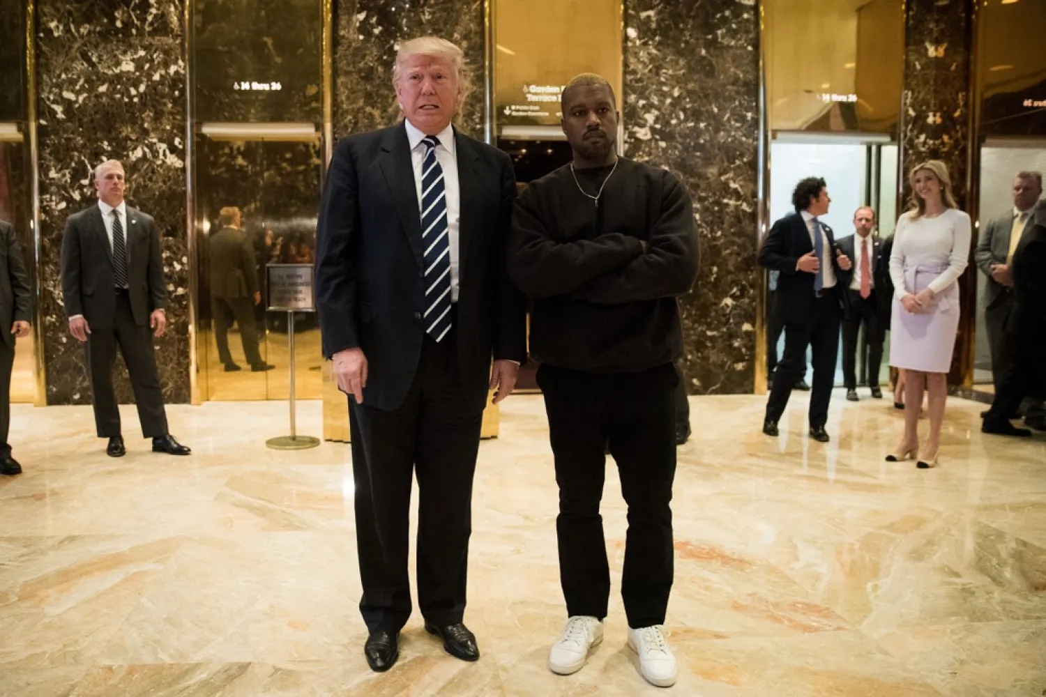 Donald Trump and Kanye West stand together in the lobby at Trump Tower, December 13, 2016 in New York City, after Trump's election victory | AFP