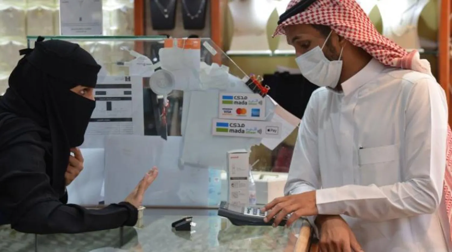 Saudis shop at a jewelry shop in the Tiba gold market in the capital Riyadh on June 29, 2020. (Photo by FAYEZ NURELDINE / AFP)