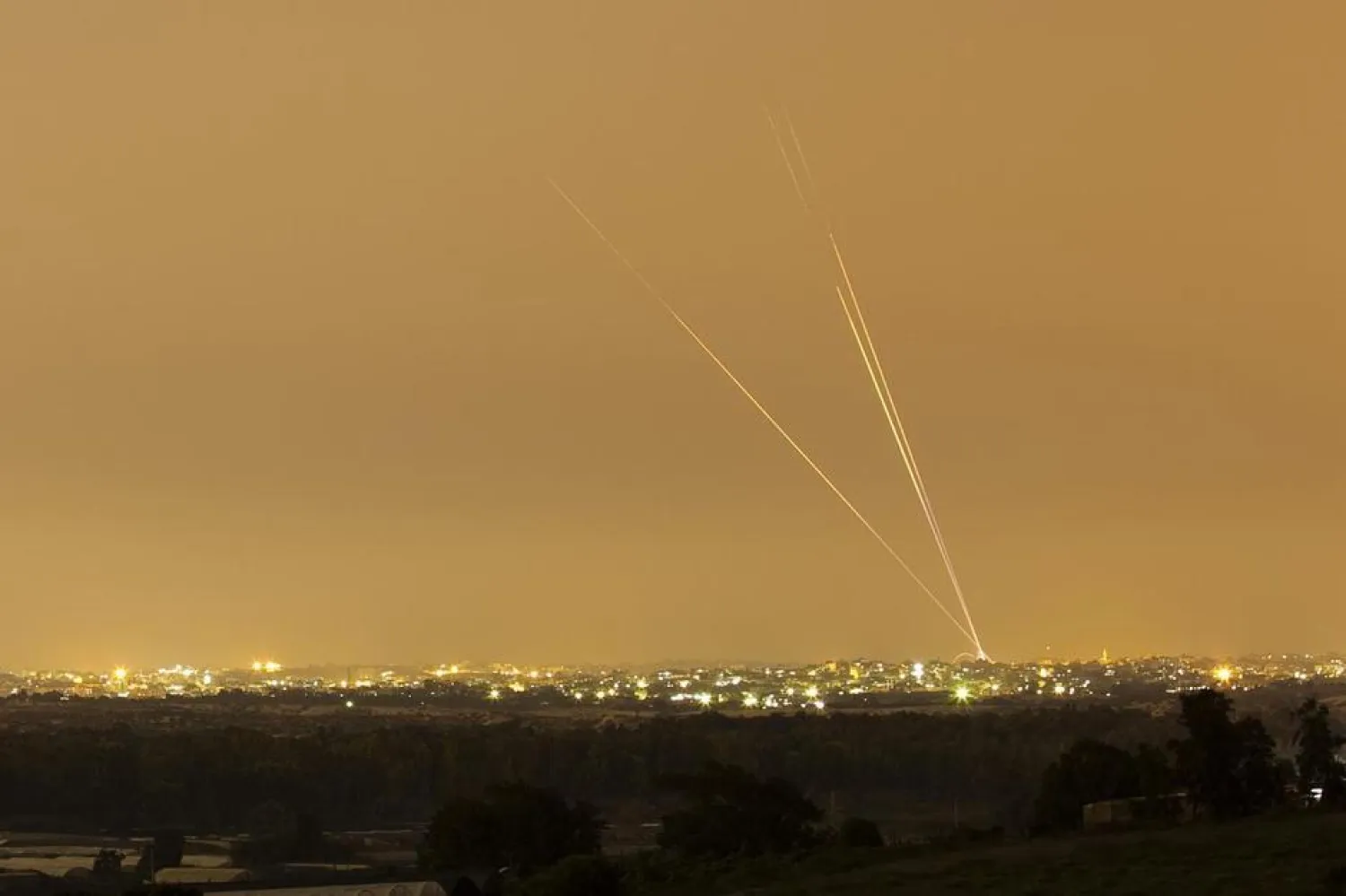 Smoke trails are seen as rockets are launched towards Israel from the northern Gaza Strip July 12, 2014. REUTERS/Amir Cohen