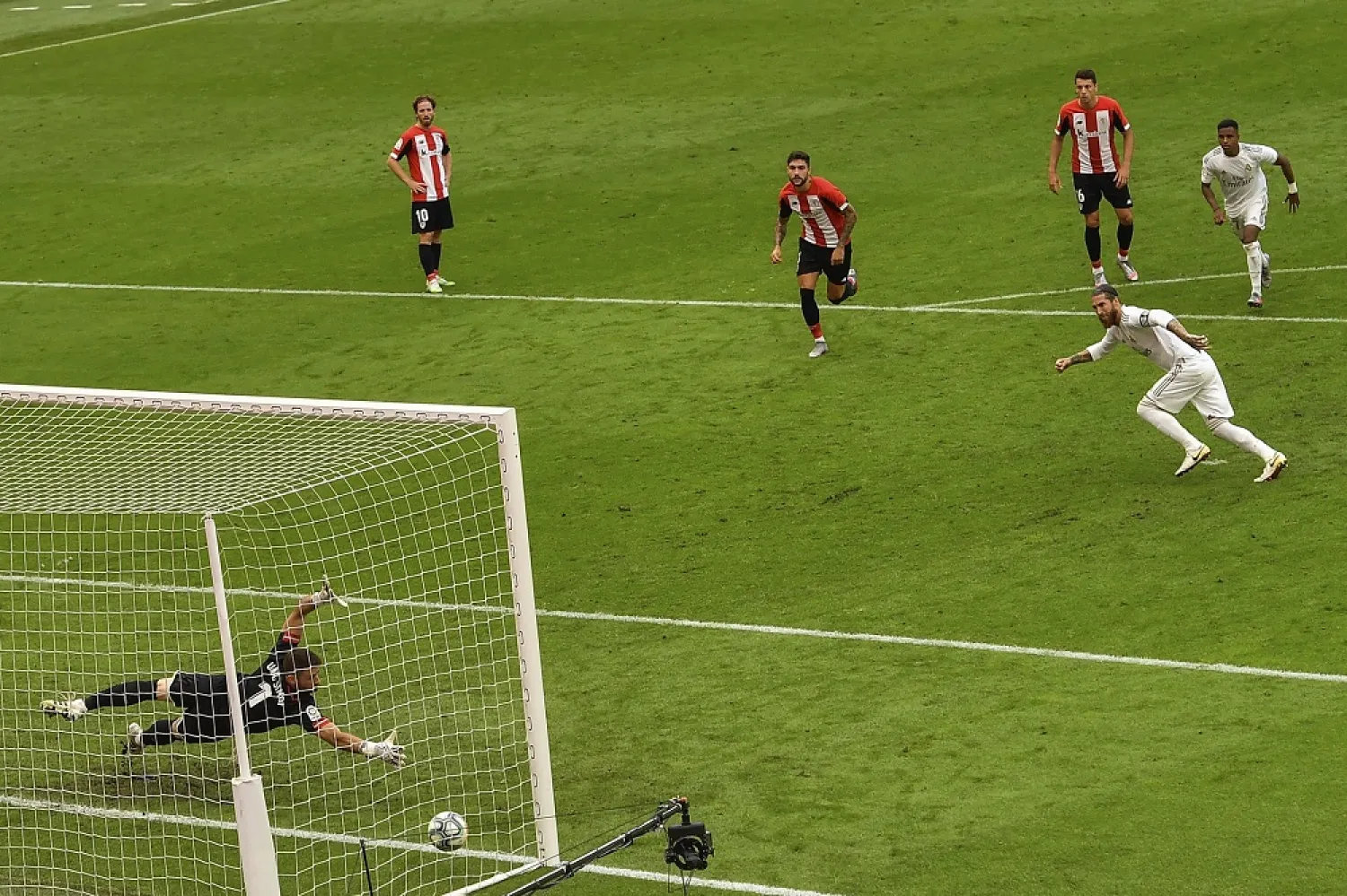 Real Madrid's Sergio Ramos, right, scores from a penalty during the Spanish La Liga match between Athletic Club and Real Madrid at the San Manes stadium in Bilbao, Spain, July 5, 2020. (AP)