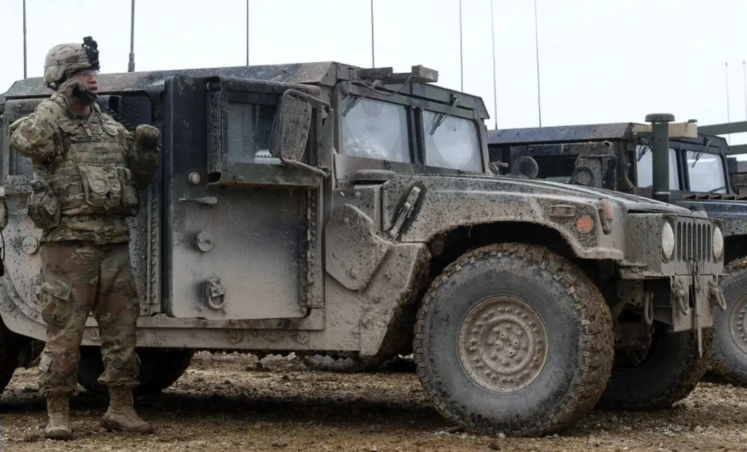 A US soldier stands next to armored vehicles during an artillery live fire event by the US Army Europe's 41st Field Artillery Brigade at the military training area in Grafenwoehr, southern Germany, March 4, 2020 | AFP