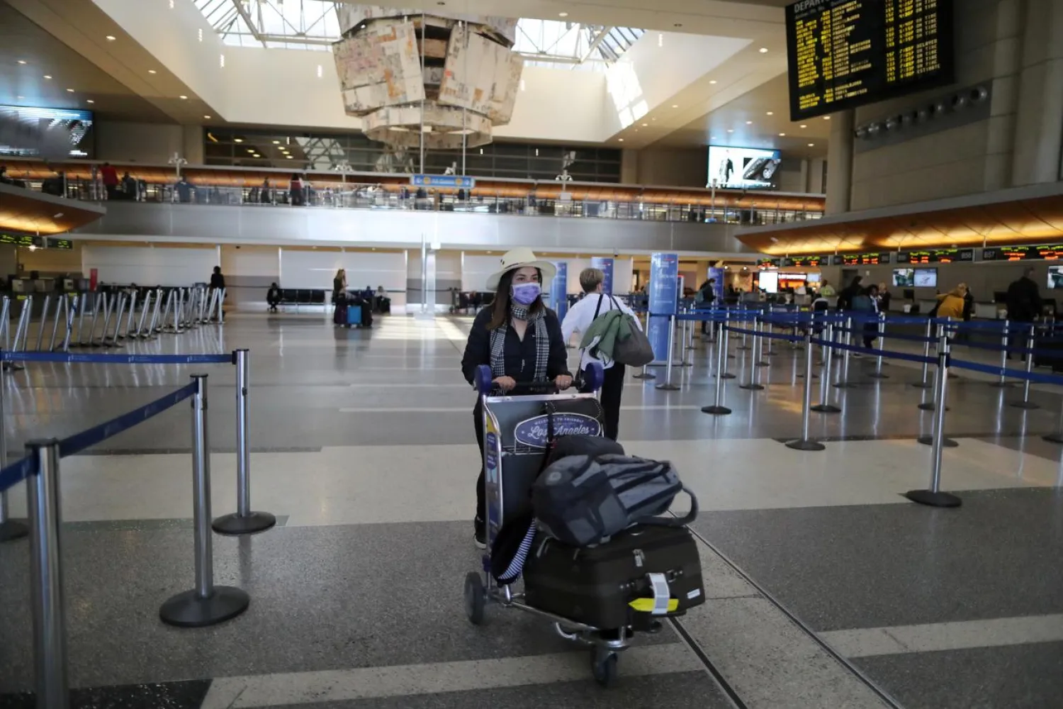A woman walks through the empty international terminal at LAX airport in Los Angeles, California, US, amid reports of the coronavirus, March 11, 2020. (Reuters)