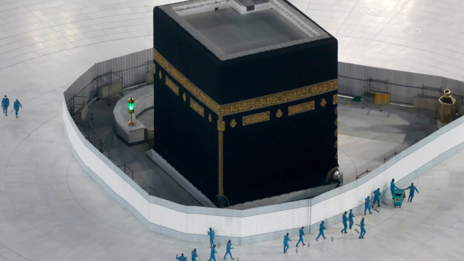 In this March 7, 2020 file photo, workers disinfect the ground around the Kaaba, the cubic building at the Grand Mosque, over fears of the new coronavirus, the Muslim holy city of Mecca, Saudi Arabia. Guidelines were announced Monday, July 6, 2020 as Saudi Arabia gets ready for the 1,000 or so pilgrims that will be allowed to perform the hajj pilgrimage in Mecca later this month. The experience will be unlike any before which usually draws some 2.5 million people. (AP Photo/Amr Nabil, File)