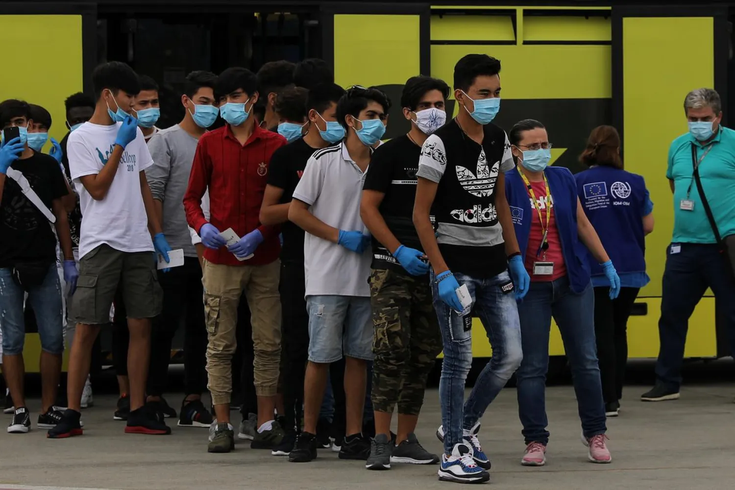 Unaccompanied refugee minors board an aircraft that will transfer them to Portugal from the Eleftherios Venizelos International Airport in Athens, Greece July 7, 2020. (Reuters)