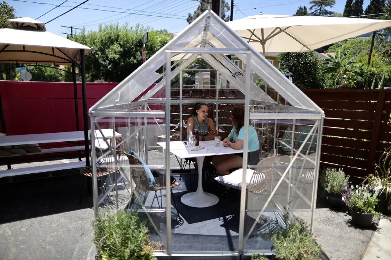 A Los Angeles cafe has filled its parking lot with individual greenhouse dining pods to help diners feel safe during the coronavirus pandemic. (Reuters)