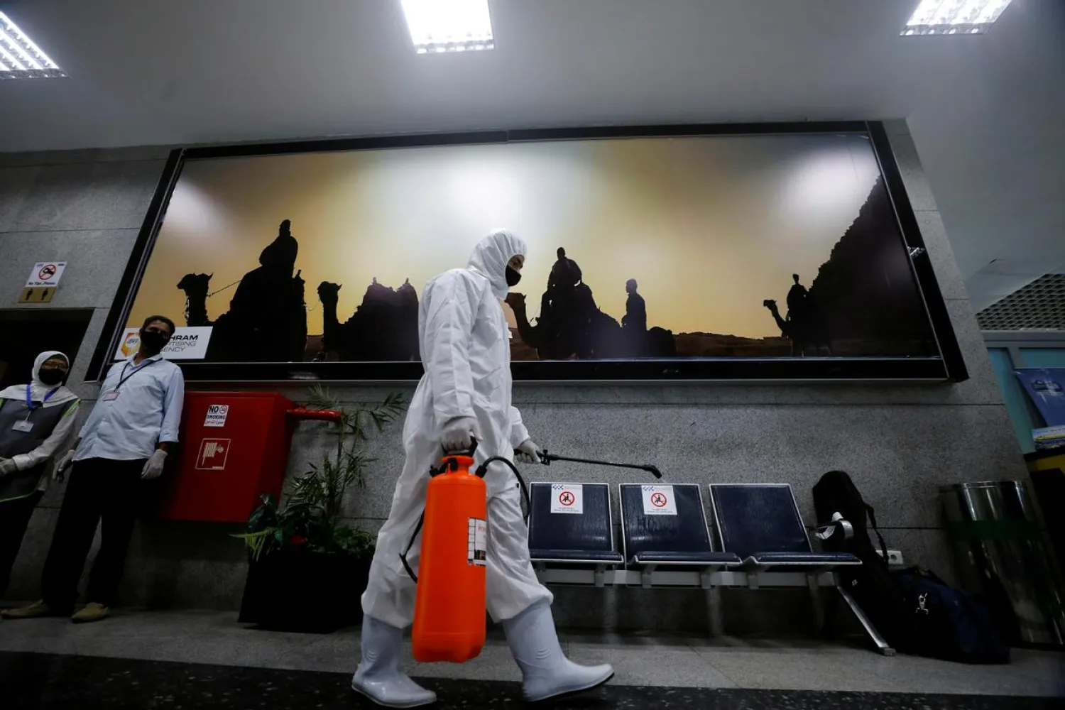 A worker wears protective gear as he sprays disinfectant, following an outbreak of the coronavirus, at Hurghada International Airport in Hurghada, Egypt, June 18, 2020. (Reuters)