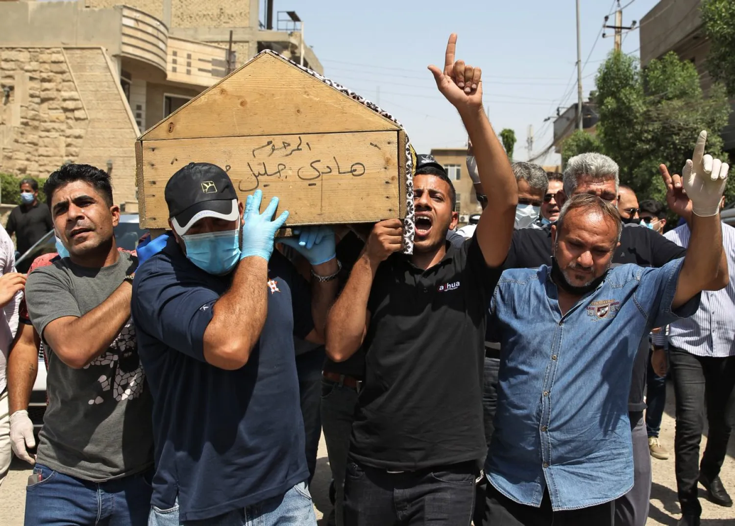Mourners carry the coffin of Iraqi security expert Hisham al-Hashemi, who was shot dead outside his house in the Iraqi capital | AFP