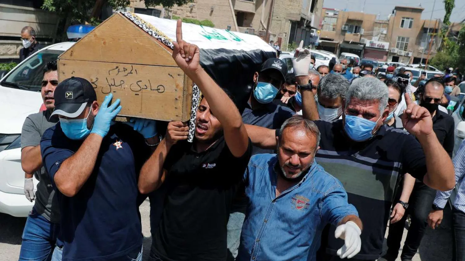 Mourners carry Hisham al-Hashemi’s coffin during the funeral in Baghdad, Iraq. (Reuters)