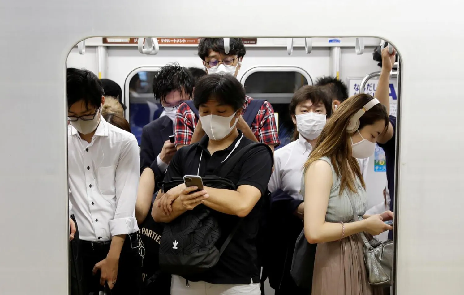 Passengers wearing protective masks amid the coronavirus outbreak, ride a subway train in Tokyo, Japan, July 3, 2020. (Reuters)