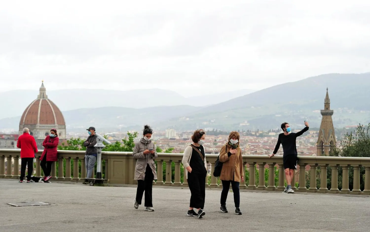 People stand and walk in Piazzale Michelangelo in Florence, Italy, May 1, 2020. (Reuters)