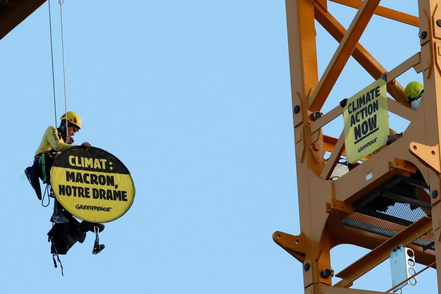 Greenpeace activists display a banner that reads: “Climate: In Action” at Notre Dame Cathedral in Paris France July 9, 2020. REUTERS/Gonzalo Fuentes