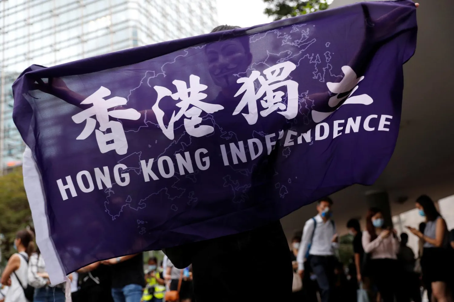 FILE PHOTO: A pro-democracy demonstrator holds a flag supporting Hong Kong Independence during a protest to mark the first anniversary of a mass rally against the now-withdrawn extradition bill, in Hong Kong, China June 9, 2020. REUTERS/Tyrone Siu