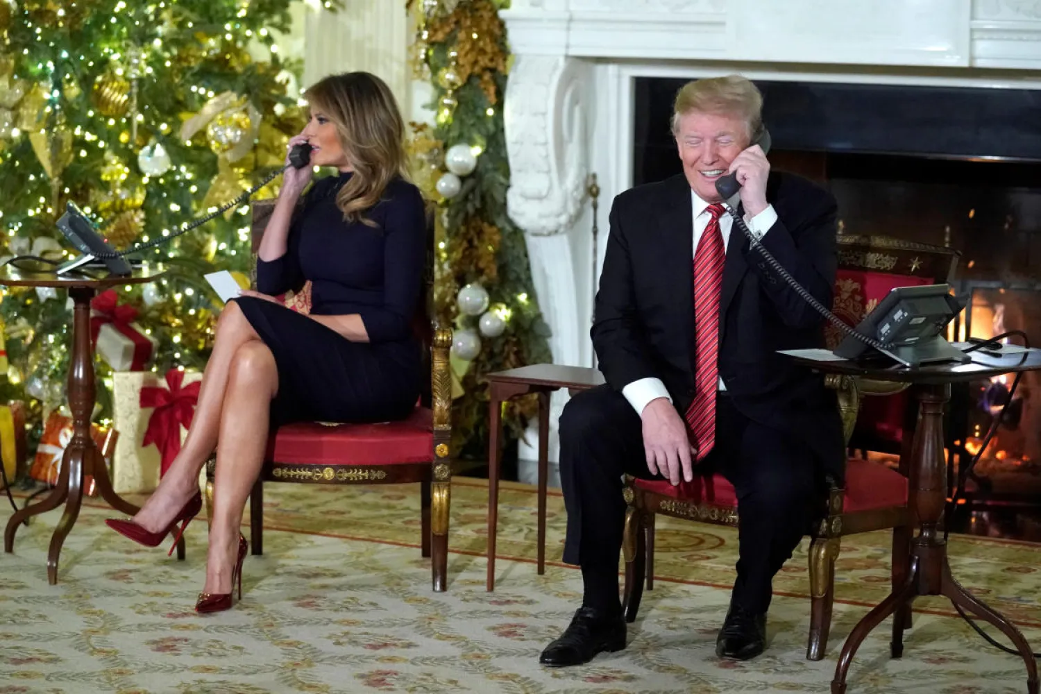 US President Donald Trump and first lady Melania Trump
participate in NORAD Santa tracker phone calls from the White House in
Washington on Monday. (REUTERS)
