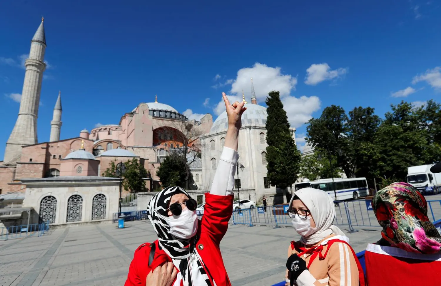 A woman gestures in front of the Hagia Sophia after a court decision that paves the way for it to be converted from a museum back into a mosque, in Istanbul, Turkey, July 10, 2020. (Reuters)