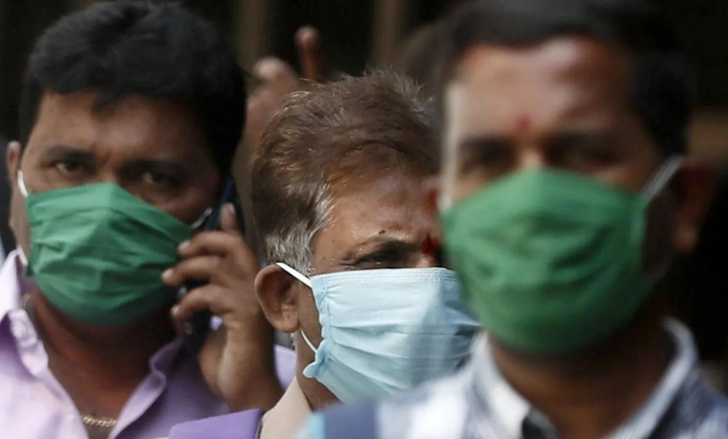 FILE PHOTO: Men wearing protective masks walk inside the premises of a hospital where a special ward has been set up for the coronavirus disease in Mumbai, India, March 17, 2020. REUTERS/Francis Mascarenhas/File Photo

