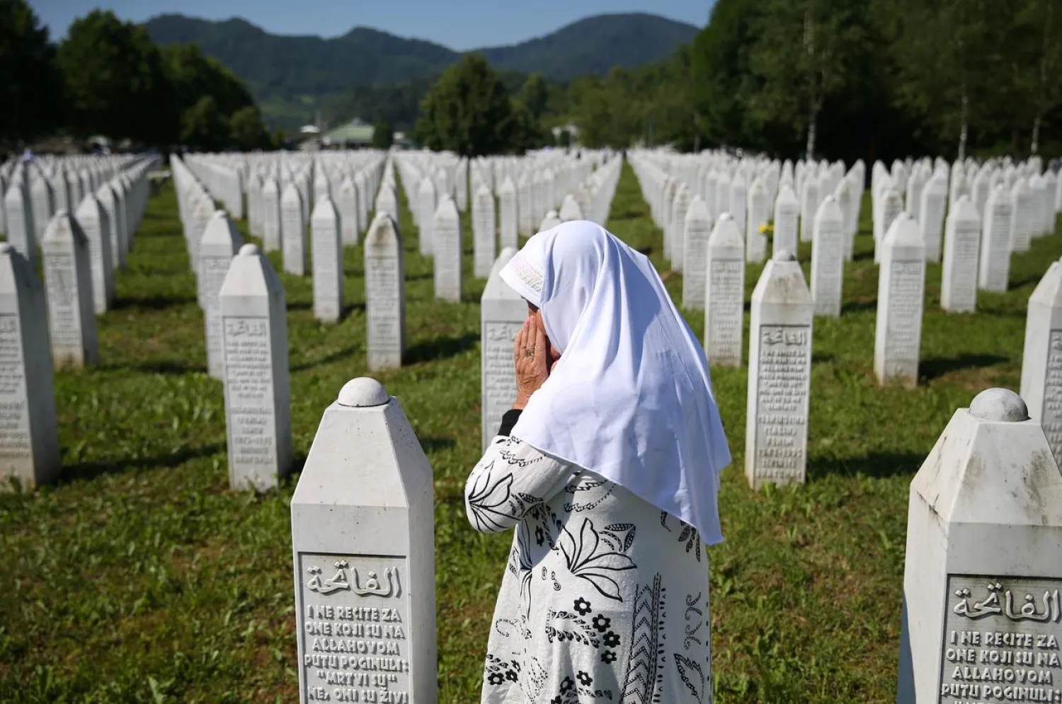 A woman prays at a graveyard, ahead of a mass funeral in Potocari near Srebrenica, Bosnia and Herzegovina July 11, 2020. (Reuters)