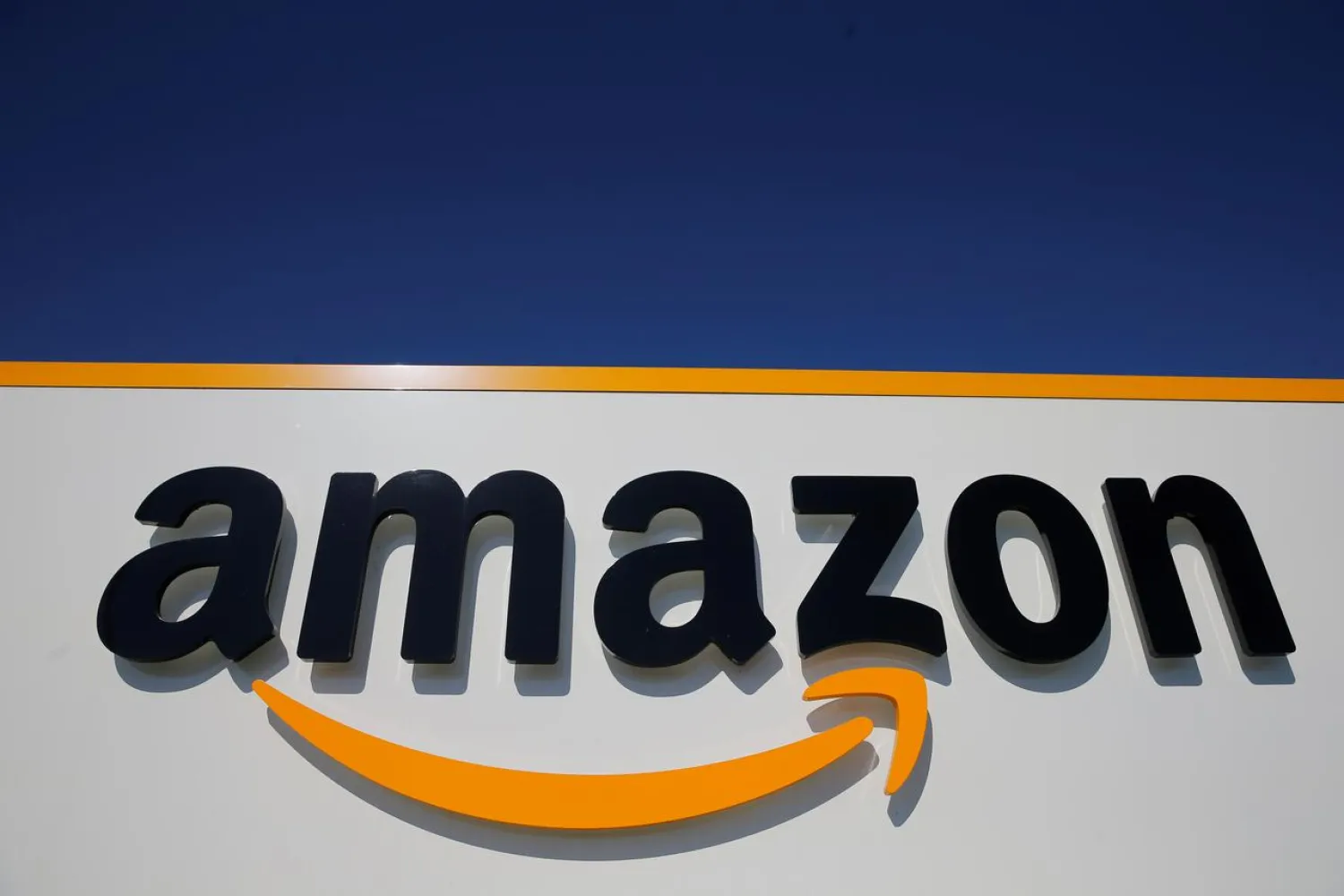 FILE PHOTO: The logo of Amazon is seen at the company logistics center in Lauwin-Planque, northern France, April 22, 2020. REUTERS/Pascal Rossignol