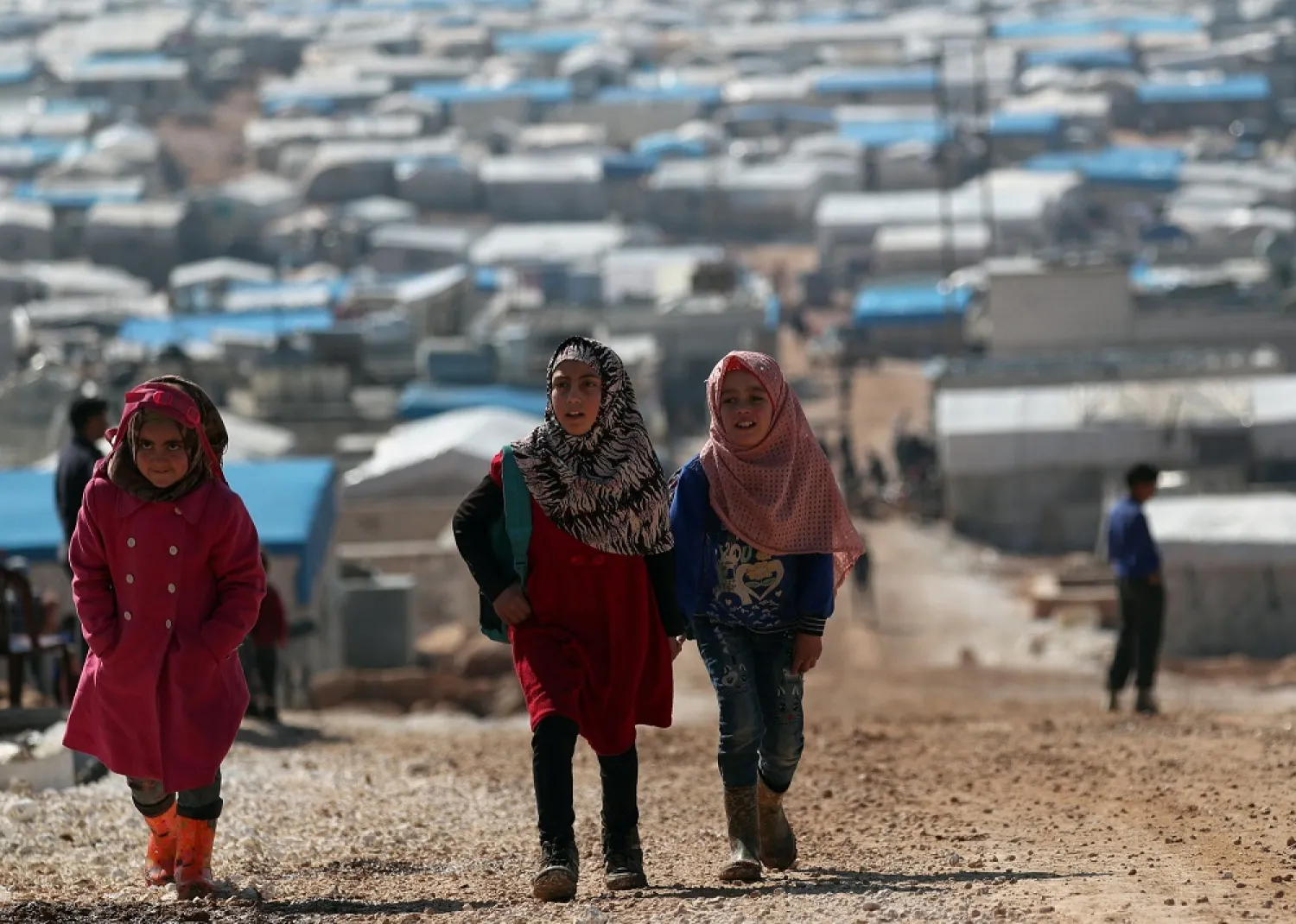 Internally displaced Syrian students walk together in Atmeh IDP camp, located near the border with Turkey, Syria March 4, 2020. (Reuters)