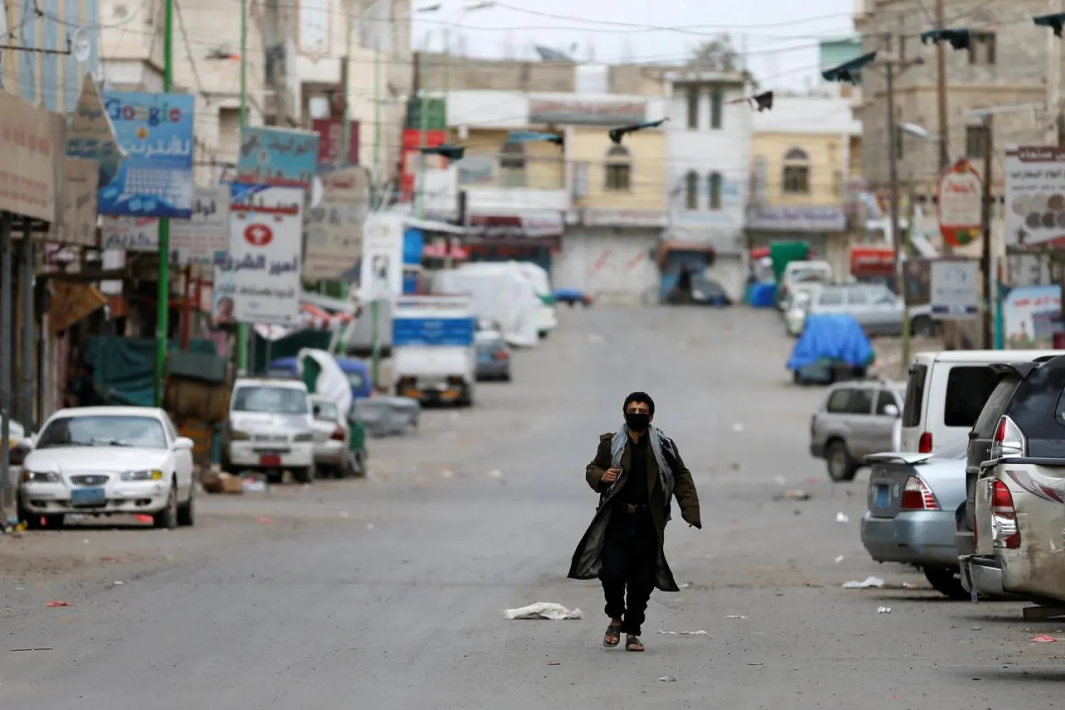 A man wearing a protective mask walks on a street during a 24-hour curfew amid concerns about the spread of the coronavirus, in Sanaa, Yemen May 6, 2020. (Reuters)
