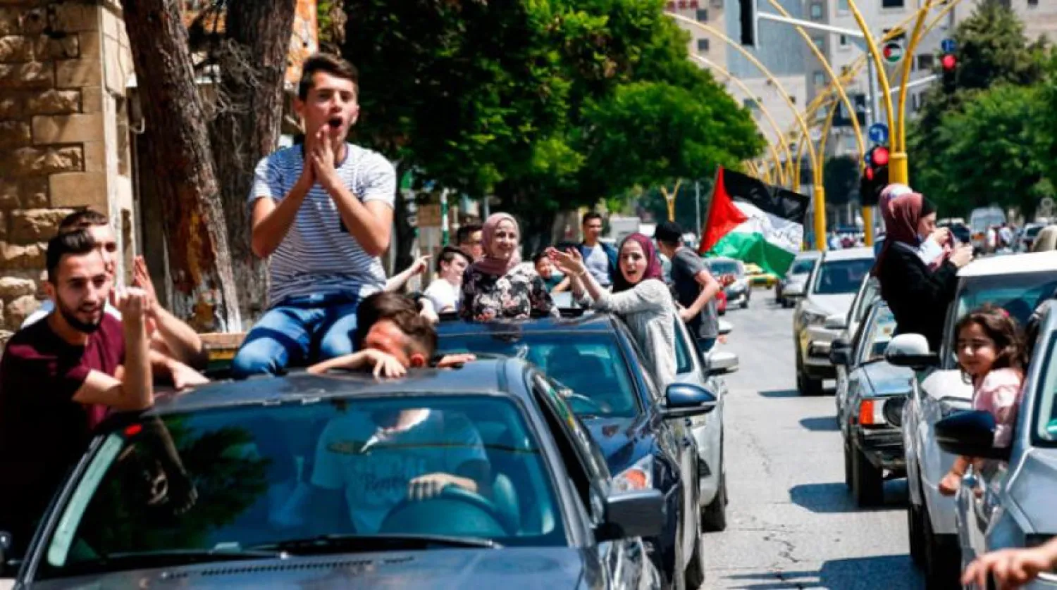 Palestinian students celebrate their exam results  (AFP)
